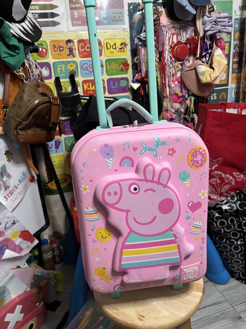 Smiggle Peppa Pig Pink Rolling Luggage (Authentic Smiggle) (Category: Babies & Kids Fashion) located in Pasig City. Submitted by genyzk (Listing ID 1462342943, Image 1). Description: - Adorable Peppa Pig rolling luggage - a vibrant pink with charming Peppa Pig graphics. - Luggage features a retractable handle and smooth-rolling wheels for effortless travel. - A must-have gift for any enthusiastic Peppa Pig fan!.