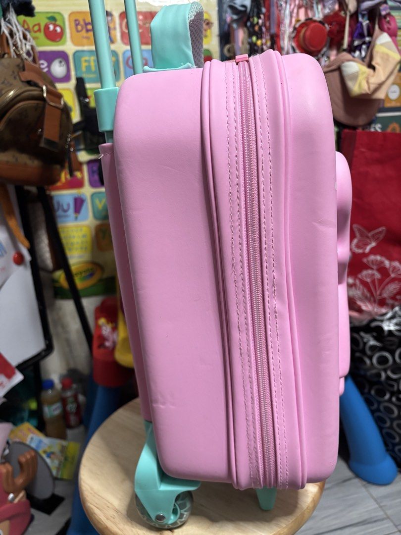 Smiggle Peppa Pig Pink Rolling Luggage (Authentic Smiggle) (Category: Babies & Kids Fashion) located in Pasig City. Submitted by genyzk (Listing ID 1462342943, Image 3). Description: - Adorable Peppa Pig rolling luggage - a vibrant pink with charming Peppa Pig graphics. - Luggage features a retractable handle and smooth-rolling wheels for effortless travel. - A must-have gift for any enthusiastic Peppa Pig fan!.