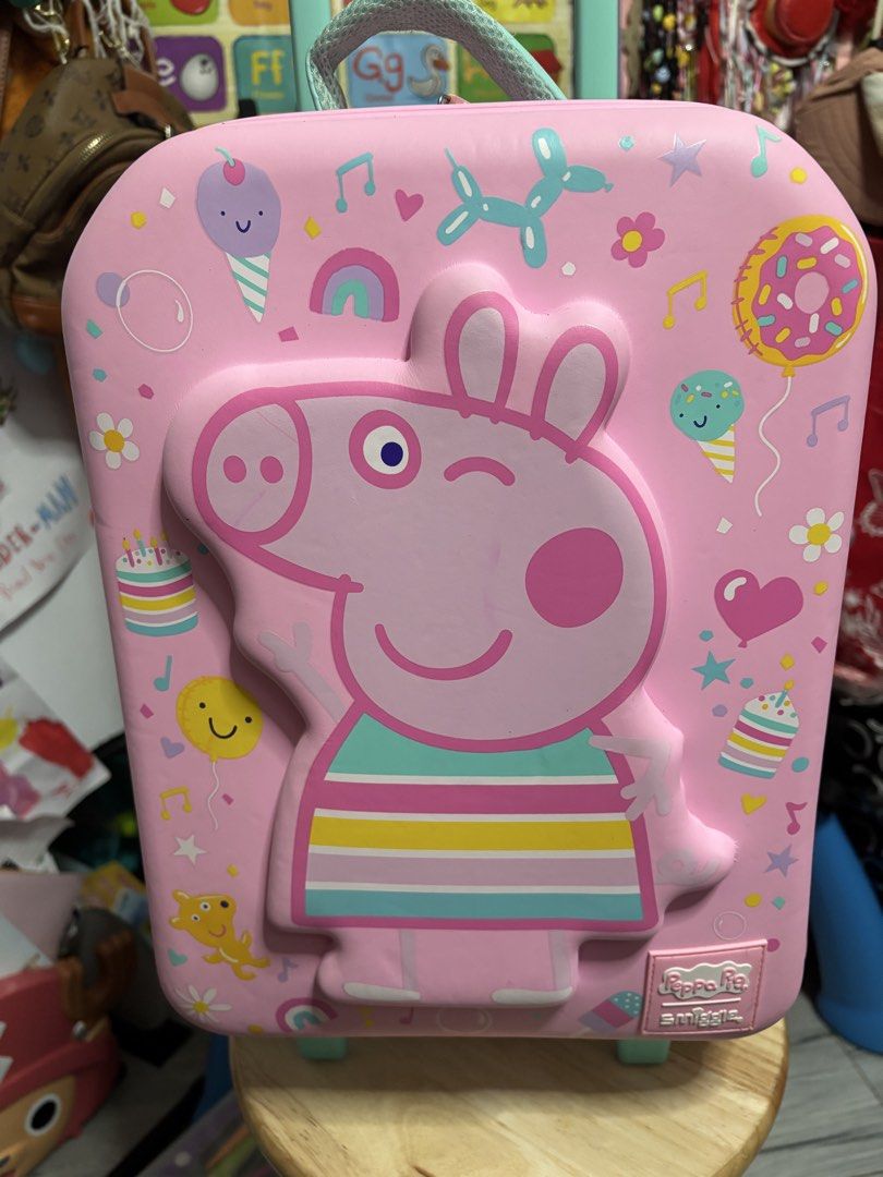 Smiggle Peppa Pig Pink Rolling Luggage (Authentic Smiggle) (Category: Babies & Kids Fashion) located in Pasig City. Submitted by genyzk (Listing ID 1462342943, Image 2). Description: - Adorable Peppa Pig rolling luggage - a vibrant pink with charming Peppa Pig graphics. - Luggage features a retractable handle and smooth-rolling wheels for effortless travel. - A must-have gift for any enthusiastic Peppa Pig fan!.