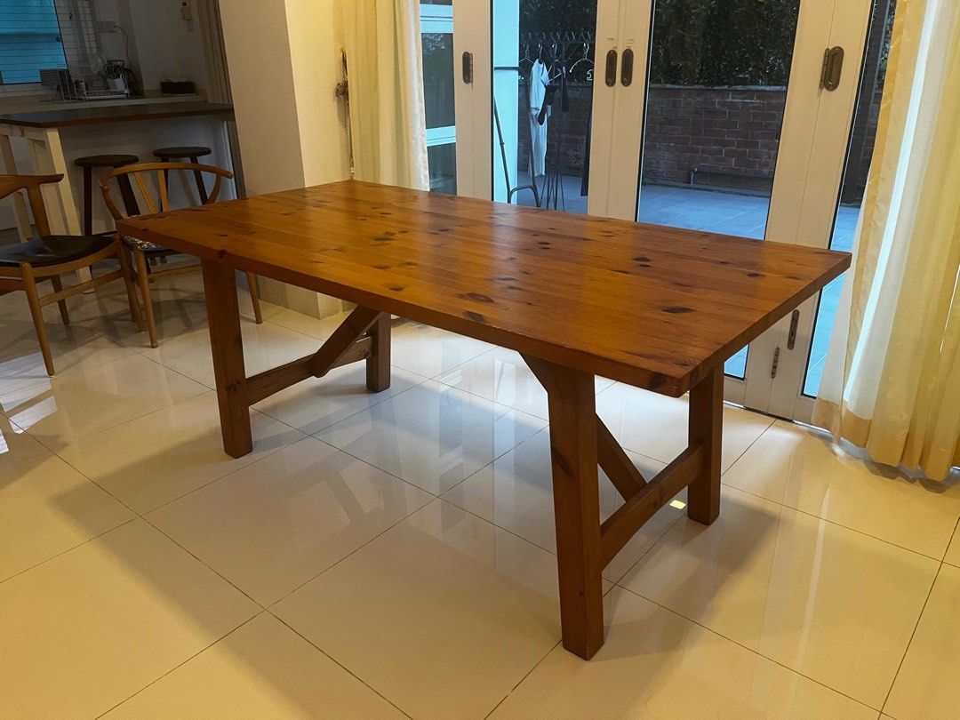 Solid Wood Dining Table (Category: Tables & Sets) located in Singapore. Submitted by dressesandsashes (Listing ID 1462352253, Image 1). Description: Solid Wood dining table. Natural wood grain and knots. Sturdy construction with cross-braced legs. Seats 6 people comfortably. This is well used but not abused. Do note that it does have markings and scratches. You’re open to come and view but this is not for fussies. Measurements: L179 cm W91 cm H76