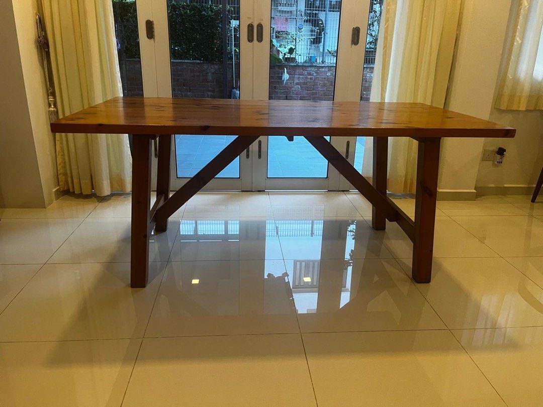 Solid Wood Dining Table (Category: Tables & Sets) located in Singapore. Submitted by dressesandsashes (Listing ID 1462352253, Image 2). Description: Solid Wood dining table. Natural wood grain and knots. Sturdy construction with cross-braced legs. Seats 6 people comfortably. This is well used but not abused. Do note that it does have markings and scratches. You’re open to come and view but this is not for fussies. Measurements: L179 cm W91 cm H76