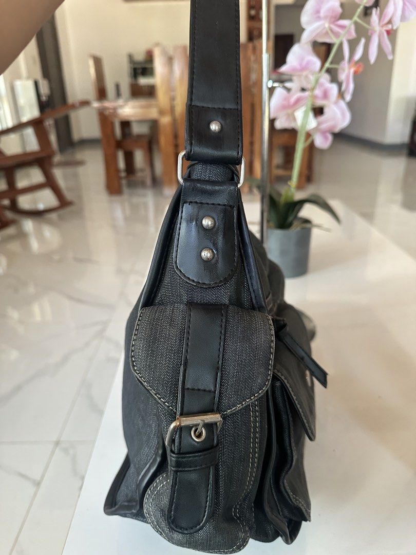 Sophie Paris Denim Hobo Bag (Category: Luxury Bags & Wallets) located in Manila. Submitted by goldenhorse-dafc (Listing ID 1462282609, Image 3). Description: - Dark wash denim hobo bag by Sophie Paris - Multiple pockets on front and sides for organization - Secure zipper closure for the main compartment - Durable leather straps and trim - Spacious interior, ideal for everyday essentials.