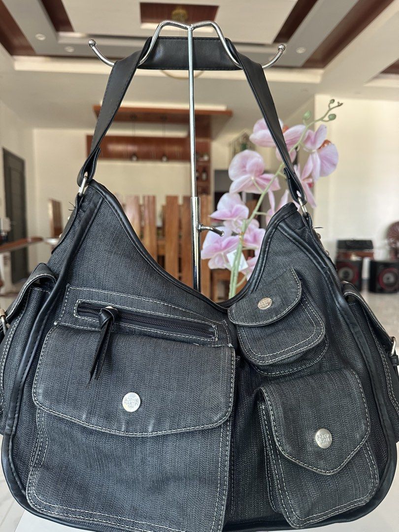 Sophie Paris Denim Hobo Bag (Category: Luxury Bags & Wallets) located in Manila. Submitted by goldenhorse-dafc (Listing ID 1462282609, Image 1). Description: - Dark wash denim hobo bag by Sophie Paris - Multiple pockets on front and sides for organization - Secure zipper closure for the main compartment - Durable leather straps and trim - Spacious interior, ideal for everyday essentials.