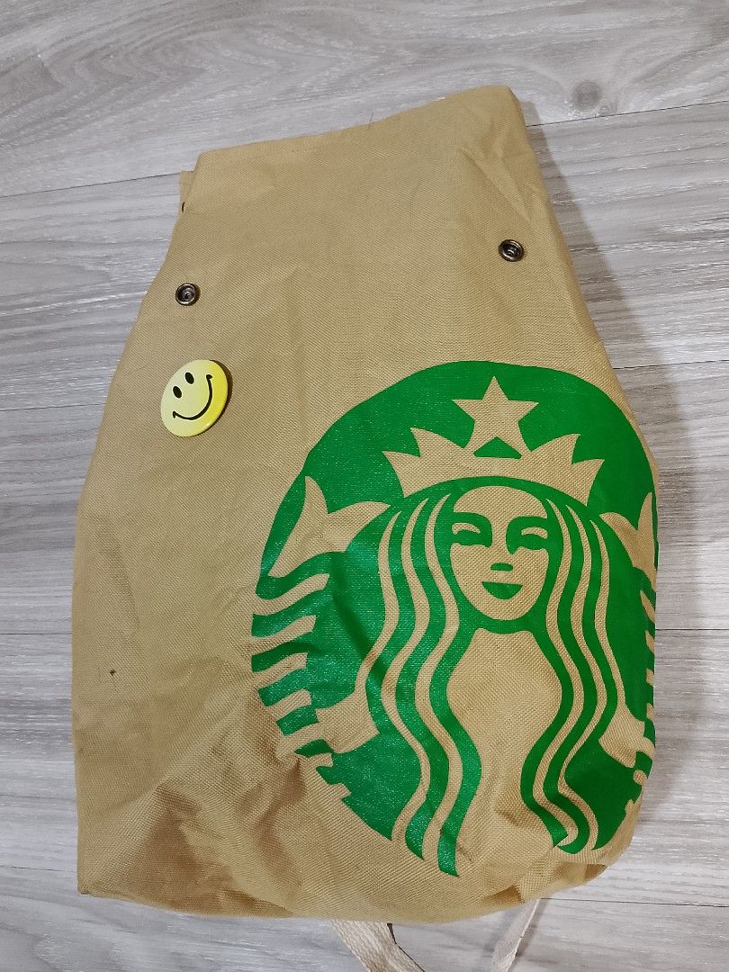 Starbucks Backpack Multifunction Canvas Bag (Category: Backpacks) located in Caloocan City. Submitted by pvaliao (Listing ID 1462372959, Image 1). Description: Starbucks Backpack Multifunction Canvas Bag This is a casual, novelty canvas backpack designed to resemble a crumbled paper bag with the iconic green Starbucks Siren logo. Pre-owned Material: cotton canvas Size: 14 inches × 19 inches Flaws: minimal cigarette burn on the strap. Price: 150 p