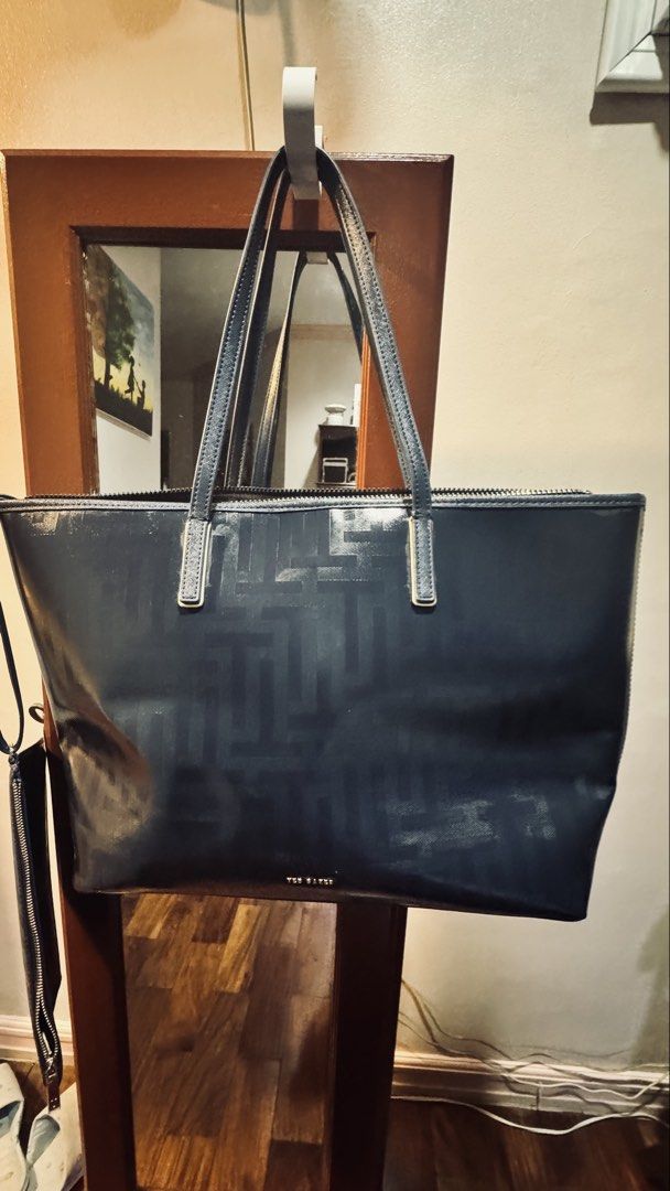 Ted Baker Bag/ Original Dark Blue Ted Baker Tote Bag (Category: Tote Bags) located in Quezon City. Submitted by gcc216 (Listing ID 1462294328, Image 2). Description: - Dark blue Ted Baker bag - All-over geometric pattern - Secure zip closure on top - Two comfortable handles - Includes a detachable strap for versatile carrying - with a detachable kikay kit or purse - Please note: some signs of wear on the surface, particularly on the handle. Kindl