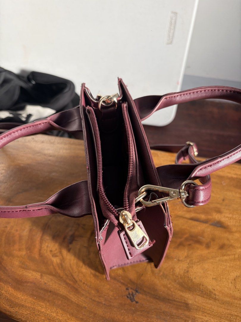 Terranova Burgundy Mini Top Handle Bag (Category: Shoulder Bags) located in Quezon City. Submitted by jasonmaverickb.1 (Listing ID 1462327915, Image 2). Description: - Cute burgundy mini bag from Terranova - Features top handles and a detachable shoulder strap - Secure zipper closure - Interior zippered pocket and slip pocket - Gold hardware details - Ideal for carrying your essentials.