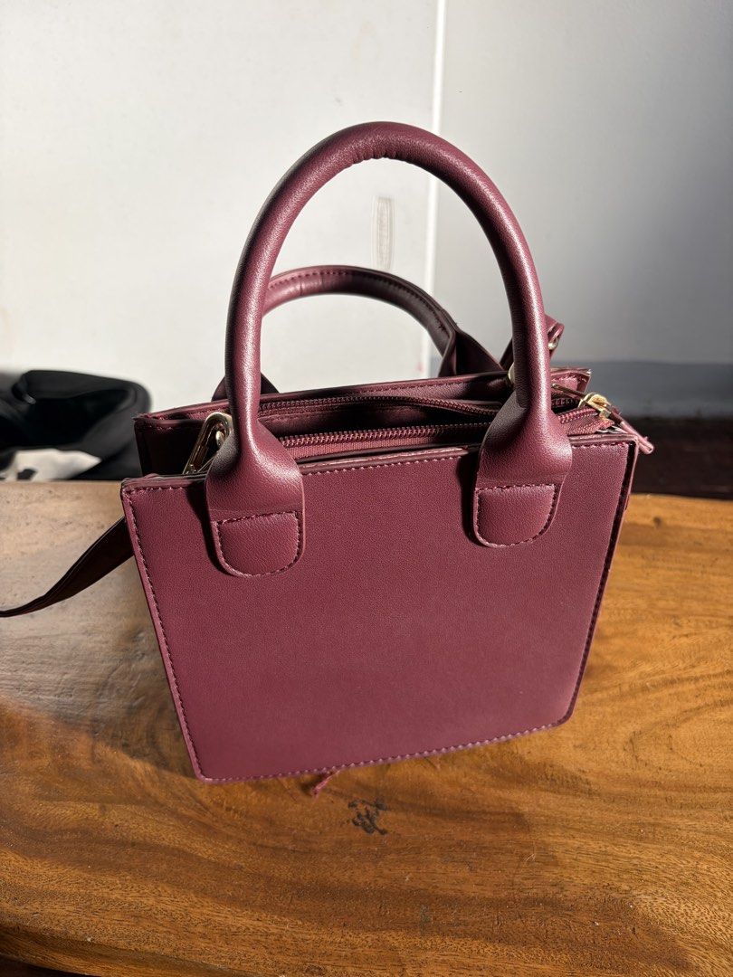 Terranova Burgundy Mini Top Handle Bag (Category: Shoulder Bags) located in Quezon City. Submitted by jasonmaverickb.1 (Listing ID 1462327915, Image 3). Description: - Cute burgundy mini bag from Terranova - Features top handles and a detachable shoulder strap - Secure zipper closure - Interior zippered pocket and slip pocket - Gold hardware details - Ideal for carrying your essentials.