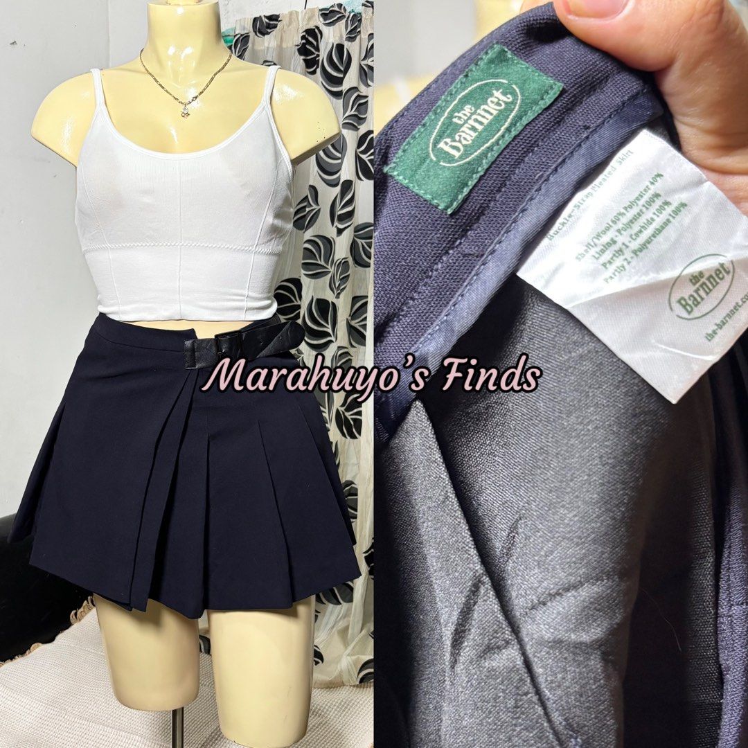The Barnnet Navy Pleated Buckle Strap Mini Skirt (Category: Skirts) located in Mabalacat. Submitted by marahuyos.finds (Listing ID 1462410402, Image 2). Description: - Navy pleated mini skirt - Brand: The Barnet - Size: Estimated S-M - Waist: 26-28 inches - Length: 15 inches - Features a stylish buckle strap detail at the waist - Versatile for preppy or casual looks - Pairs well with crop tops or blouses.