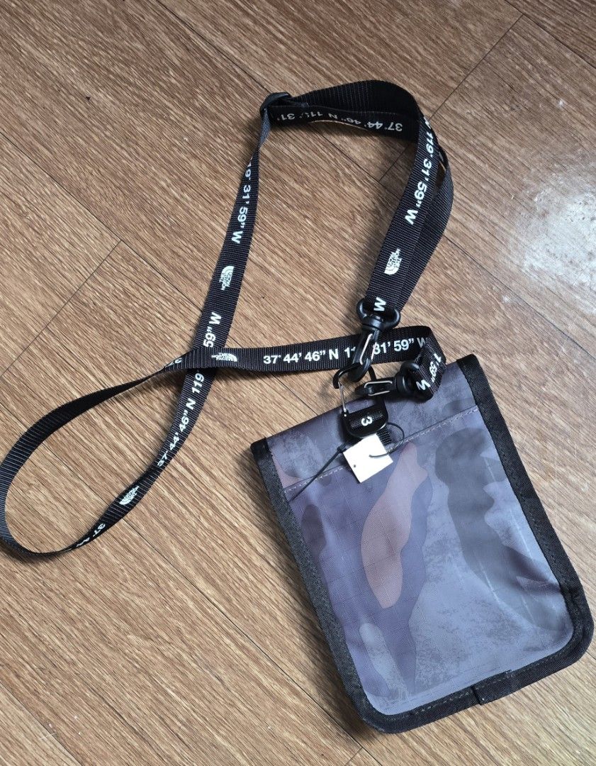 The North Face Camo Pouch with Lanyard (Category: Belt bags, Clutches and Pouches) located in Quezon. Submitted by archivesss_666 (Listing ID 1462372584, Image 2). Description: - The North Face pouch with stylish camouflage pattern. - Includes a lanyard strap with unique printed coordinates. - Secure buckle closure on the front for easy access. - Ideal for keeping your essentials organized and within reach..