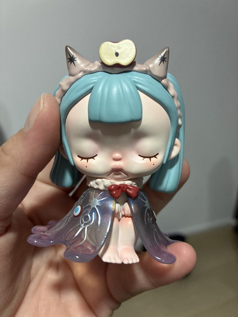 Tiny tiny (Category: Toy Figures) located in Singapore. Submitted by allitemsmustgo (Listing ID 1462370760, Image 1). Description: All new. Just for display in glass cabinet. Letting go due to moving house. - Adorable collectible figure - Light blue hair - Cute apple on headband - Translucent, iridescent cape with star details - Closed eyes and rosy cheeks - Ideal for display.