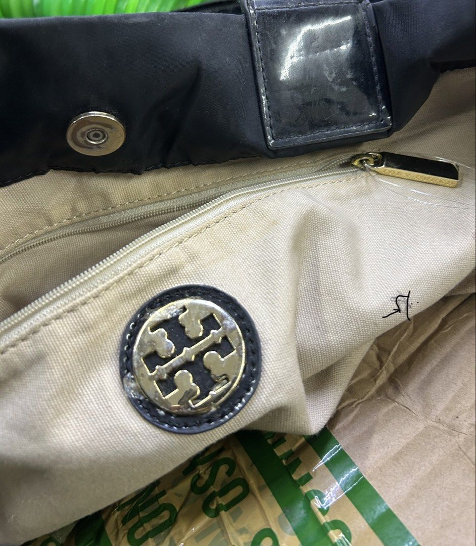 Tory Burch Black Nylon Tote Bag (Category: Tote Bags) located in Balanga. Submitted by coolwhale-76ba (Listing ID 1462406609, Image 2). Description: - Classic black Tory Burch tote bag - Made with durable nylon and patent leather accents - Spacious interior with a zippered pocket - Iconic Tory Burch logo on the front - Shiny patent leather handles - Great for everyday use or travel.