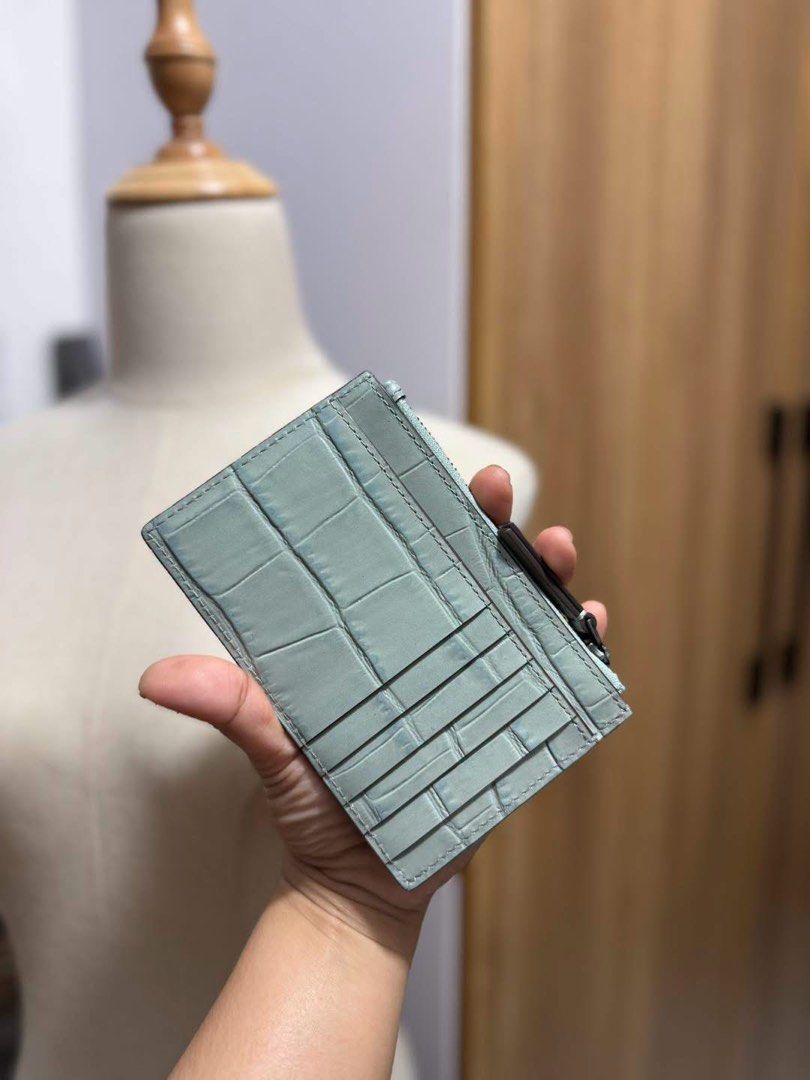 Tory Burch Croc Embossed Card Holder Pouch (Category: Wallets & Card holders) located in Manila. Submitted by clairetot (Listing ID 1462369987, Image 2). Description: Original Light blue Tory Burch card holder. Embossed croc pattern all over. Zipper closure. Has a few card slots on the back. Small and compact, great for essentials. Good for everyday use or travel..