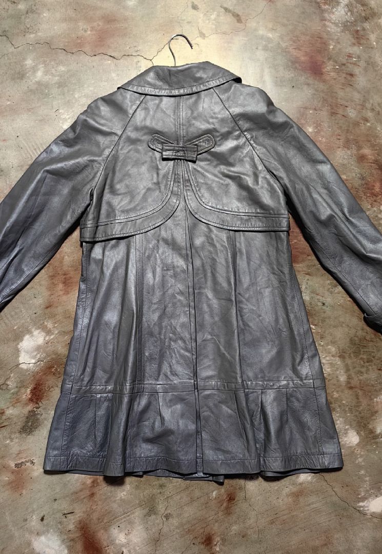 Tory Burch Grey Leather Trench Coat with Ruffle Hem (Category: Coats, Jackets and Outerwear) located in Tarlac. Submitted by jeremiah.curator.2026 (Listing ID 1462433449, Image 2). Description: - Tory Burch grey leather lambskin trench coat - Unique ruffled hem - Elegant gold button details - Classic Peter Pan collar - Versatile for dressing up or down - Ideal for transitional weather - A stylish statement piece.