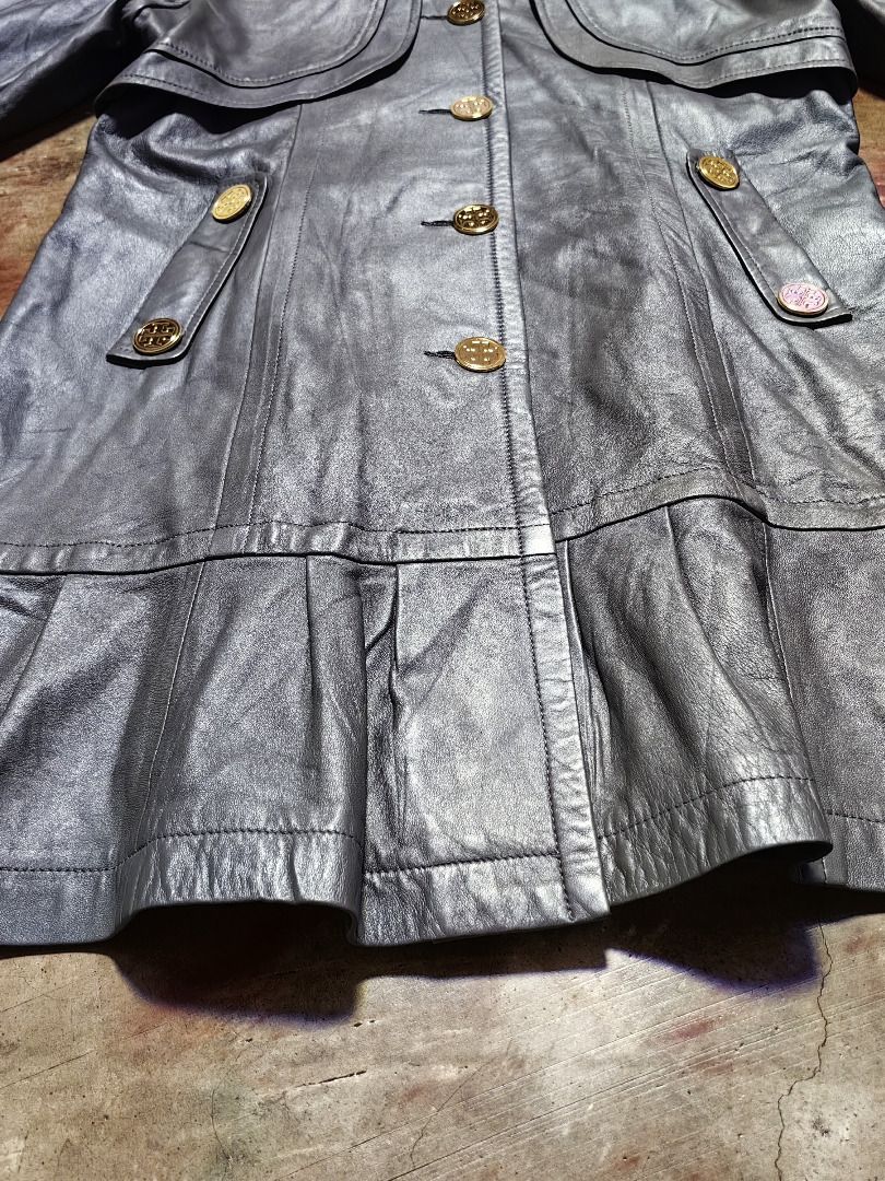 Tory Burch Grey Leather Trench Coat with Ruffle Hem (Category: Coats, Jackets and Outerwear) located in Tarlac. Submitted by jeremiah.curator.2026 (Listing ID 1462433449, Image 3). Description: - Tory Burch grey leather lambskin trench coat - Unique ruffled hem - Elegant gold button details - Classic Peter Pan collar - Versatile for dressing up or down - Ideal for transitional weather - A stylish statement piece.