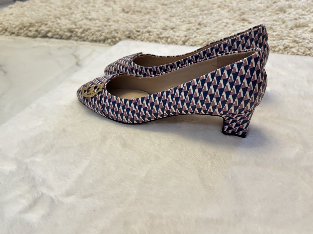 Tory Burch Printed Low-Heeled Pumps (Category: Flats & Sandals) located in San Nicolas. Submitted by ihascat (Listing ID 1462302021, Image 2). Description: - Fun geometric print Tory Burch heels - Classic Tory Burch logo buckle detail - Comfortable slip-on style - Perfect for dressing up or down - A stylish addition to any shoe collection.