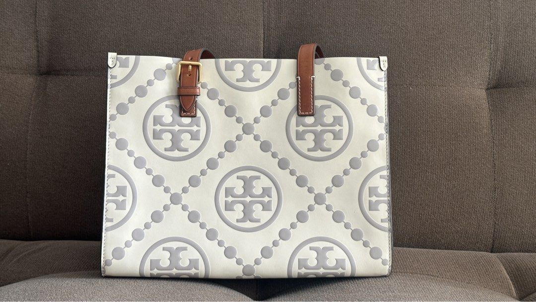 Tory Burch Small T Monogram Contrast Embossed Tote (Category: Luxury Bags & Wallets) located in Mandaluyong City. Submitted by krissshop (Listing ID 1462306679, Image 2). Description: - Authentic Tory Burch Ella Tote Bag - Signature all-over logo print - Genuine leather trim and handles - Decorative buckle detail on strap - Spacious interior for essentials - Ideal for office or everyday use.