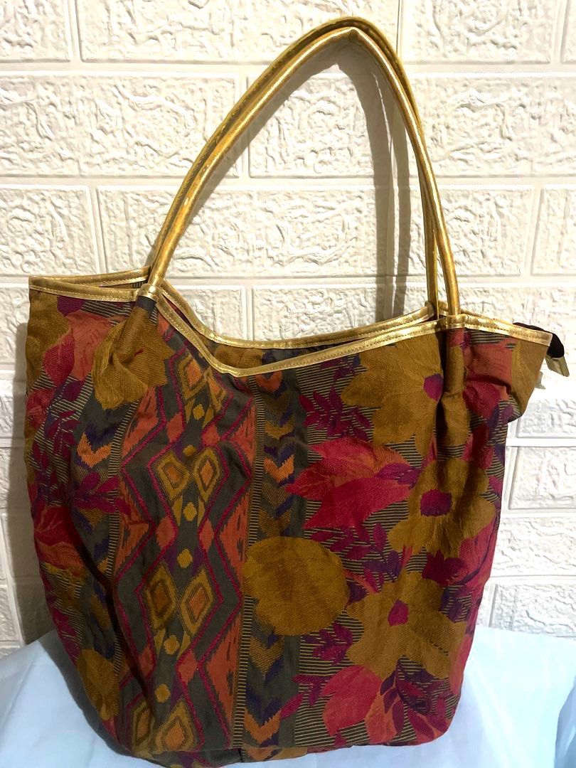 Tote Bag with Floral and Geometric Pattern (Category: Tote Bags) located in Manila. Submitted by myshanshine (Listing ID 1462360746, Image 1). Description: - Unique woven tote bag - Features a mix of floral and geometric designs - Earthy tones with elegant gold trim and handles - Spacious interior for everyday essentials or travel - Secure zipper closure.