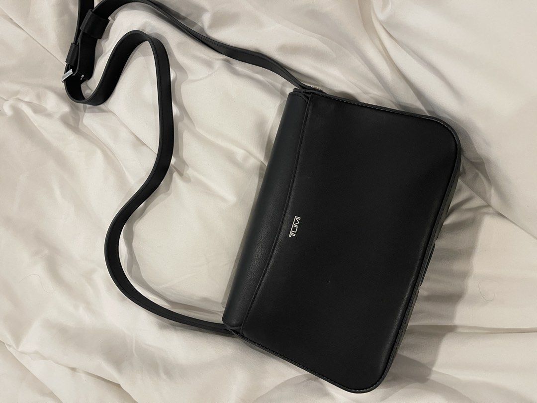 Tumi Black Leather Olas Shoulder Bag (Category: Cross-body Bags) located in San Juan City. Submitted by declutterrrsale (Listing ID 1462324643, Image 2). Description: Barely used! Good as brand new. Selling for almost half the price. Store price is 45K! RFS: not using - Brand: Tumi - Material: Black Leather - Design: Sleek with silver hardware accents - Strap: Adjustable for comfortable wear - Interior: Multiple compartments for organization - Be