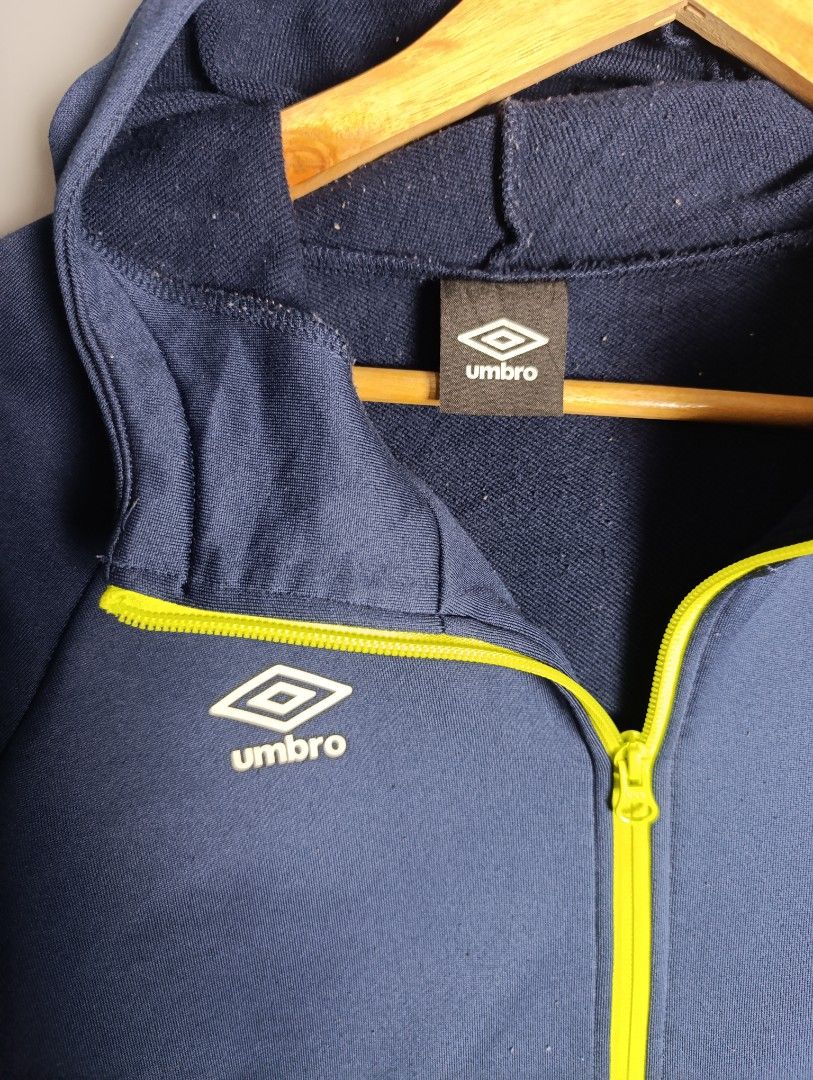 Umbro Navy Blue Zip-Up Hoodie Jacket (Category: Coats, Jackets and Outerwear) located in Magalang. Submitted by acethriftonlineshop (Listing ID 1462433319, Image 2). Description: Umbro Full-Zip Hoodie Track Jacket Dimension: 23 x 28 Size: L-XL Price: 549.