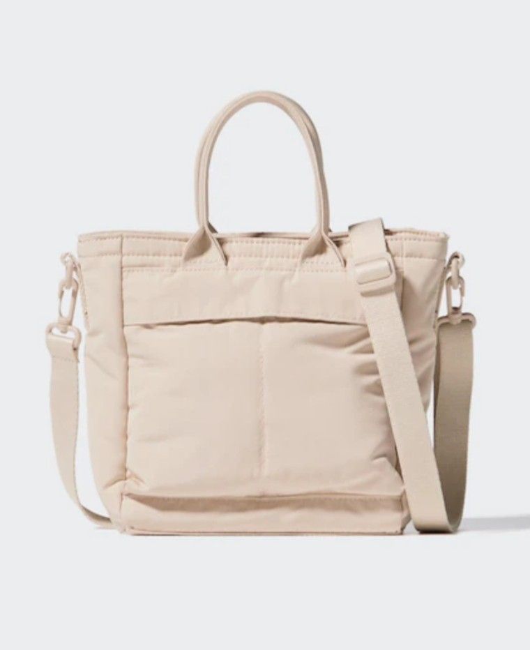 Uniqlo 2-way Utility Bag (Category: Tote Bags) located in San Fernando. Submitted by tita_finds (Listing ID 1462292966, Image 3). Description: - Uniqlo 2-way Utility Bag - Color: Beige - Features water-repellent finish - Can be worn as a hand bag or shoulder bag - Includes adjustable strap - Ideal for everyday use - Surprisingly spacious interior.