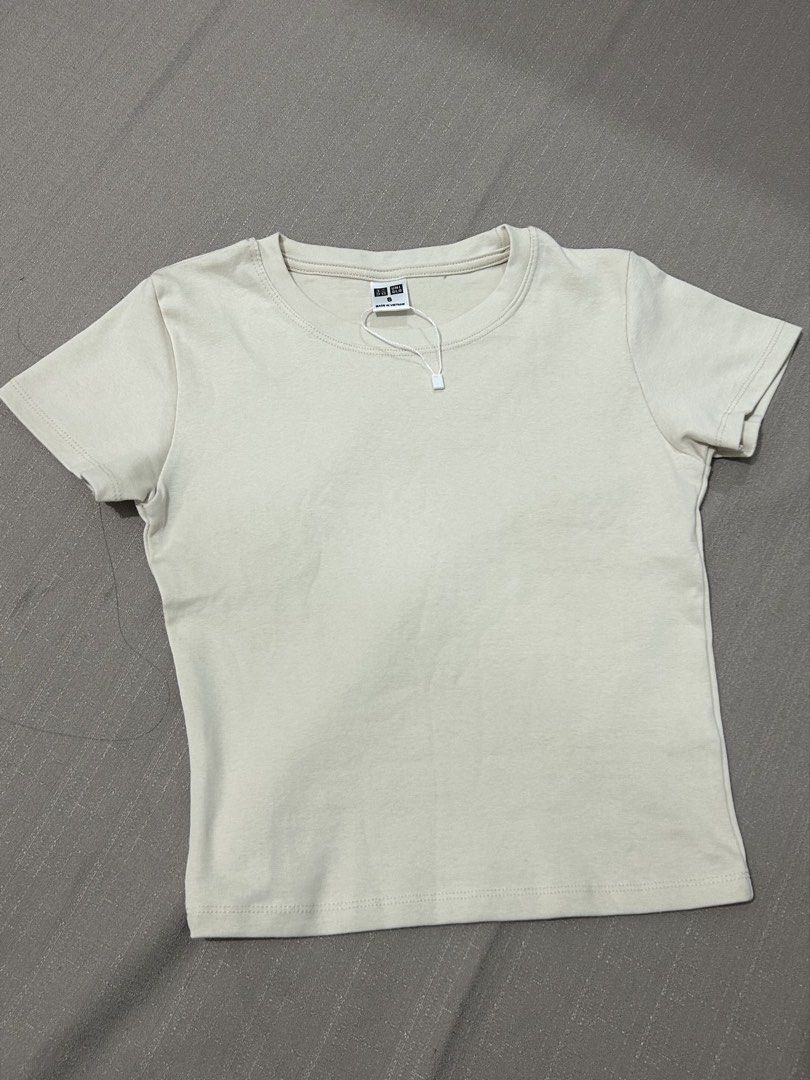 Uniqlo Basic T-Shirt Size S Cream (Category: Shirts) located in Quezon City. Submitted by hygge.elements (Listing ID 1462399436, Image 1). Description: - Cream colored croptop Uniqlo T-shirt - Size: S - Short sleeves, crew neck - Made in Vietnam - Soft fabric for ultimate comfort - Versatile for layering or solo wear - originally price Php 790.