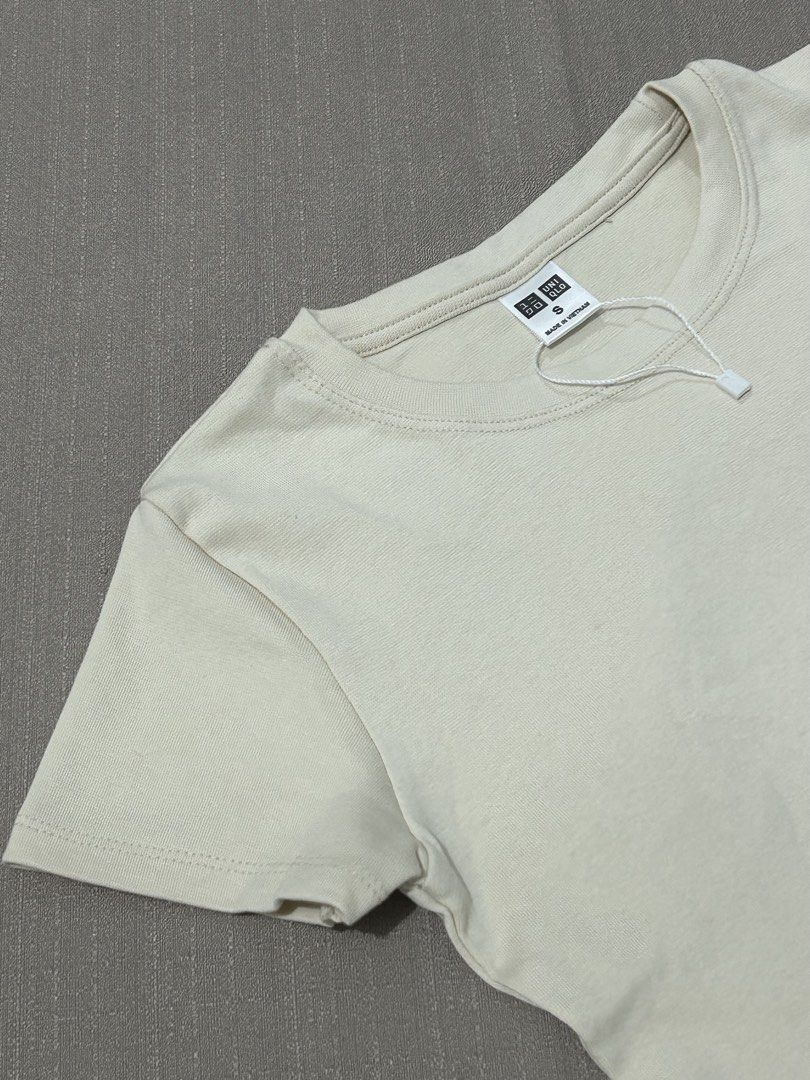 Uniqlo Basic T-Shirt Size S Cream (Category: Shirts) located in Quezon City. Submitted by hygge.elements (Listing ID 1462399436, Image 3). Description: - Cream colored croptop Uniqlo T-shirt - Size: S - Short sleeves, crew neck - Made in Vietnam - Soft fabric for ultimate comfort - Versatile for layering or solo wear - originally price Php 790.