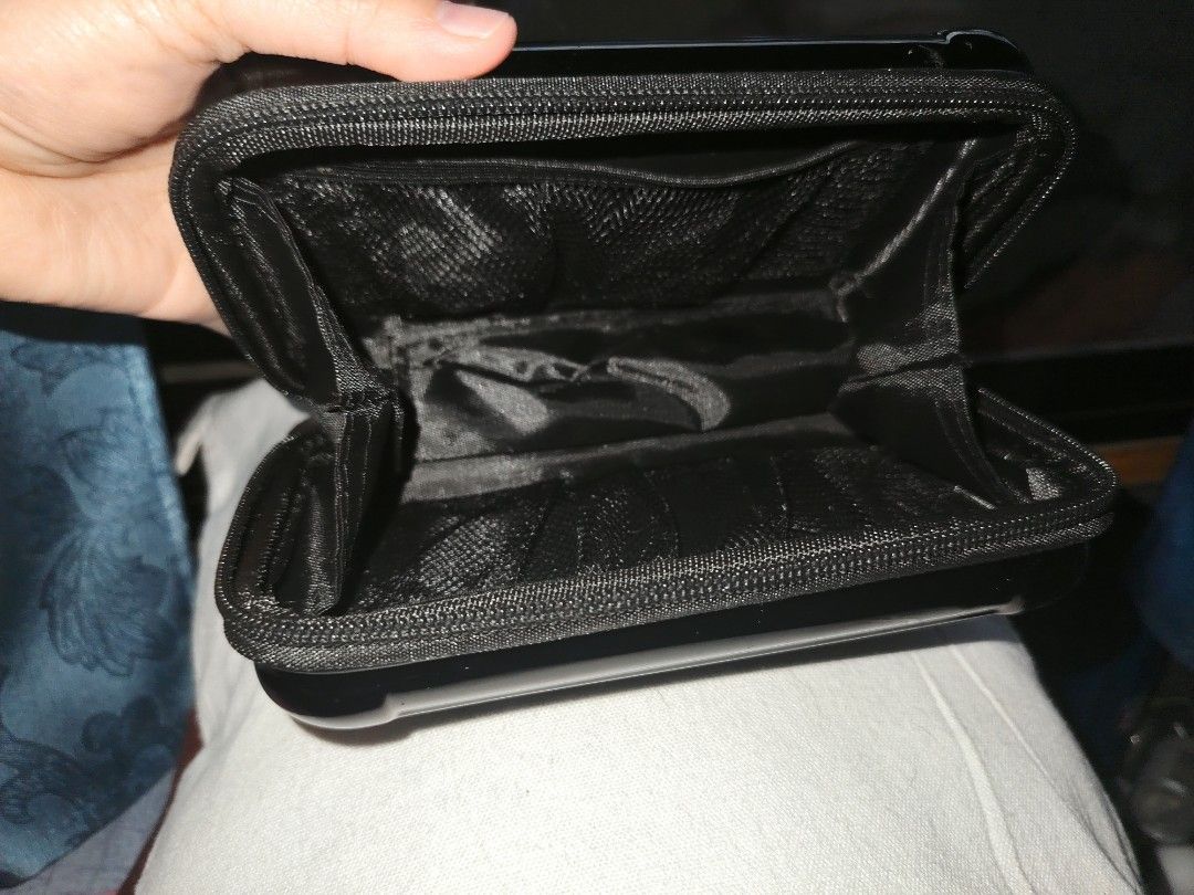 UNIQLO Limited Edition Black Hard Shell Bag (Category: Purses & Pouches) located in Dipolog. Submitted by queenibee01 (Listing ID 1462327627, Image 3). Description: - UNIQLO Black Hard Shell Cosmetic Bag - Secure zippered closure - Convenient wrist strap - Internal mesh pockets for organization - Ideal for travel or everyday use - Compact and easy to carry.