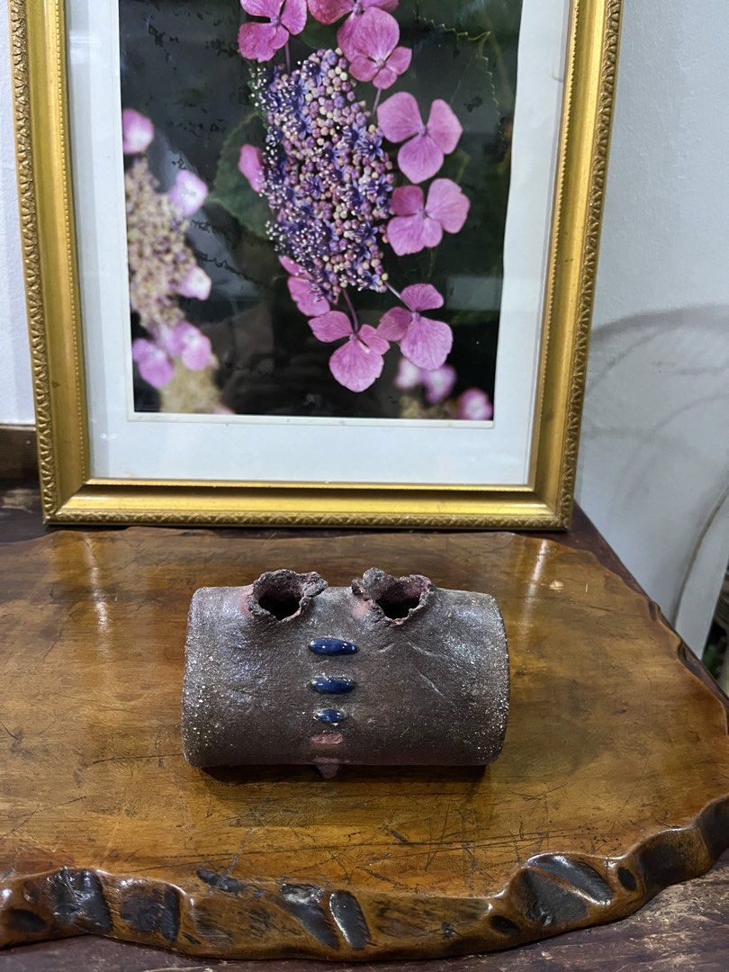 Unique Ceramic Vase with Blue Accents (Category: Vases & Decorative Bowls) located in Taguig. Submitted by minmin_parker (Listing ID 1462397871, Image 2). Description: - Handmade ceramic vase with a unique textured finish. - Adorned with small blue bead-like accents down the front. - Features two openings at the top. - Ideal for displaying small dried flowers or as a standalone decorative piece. - Brings a touch of rustic charm to any room. - App