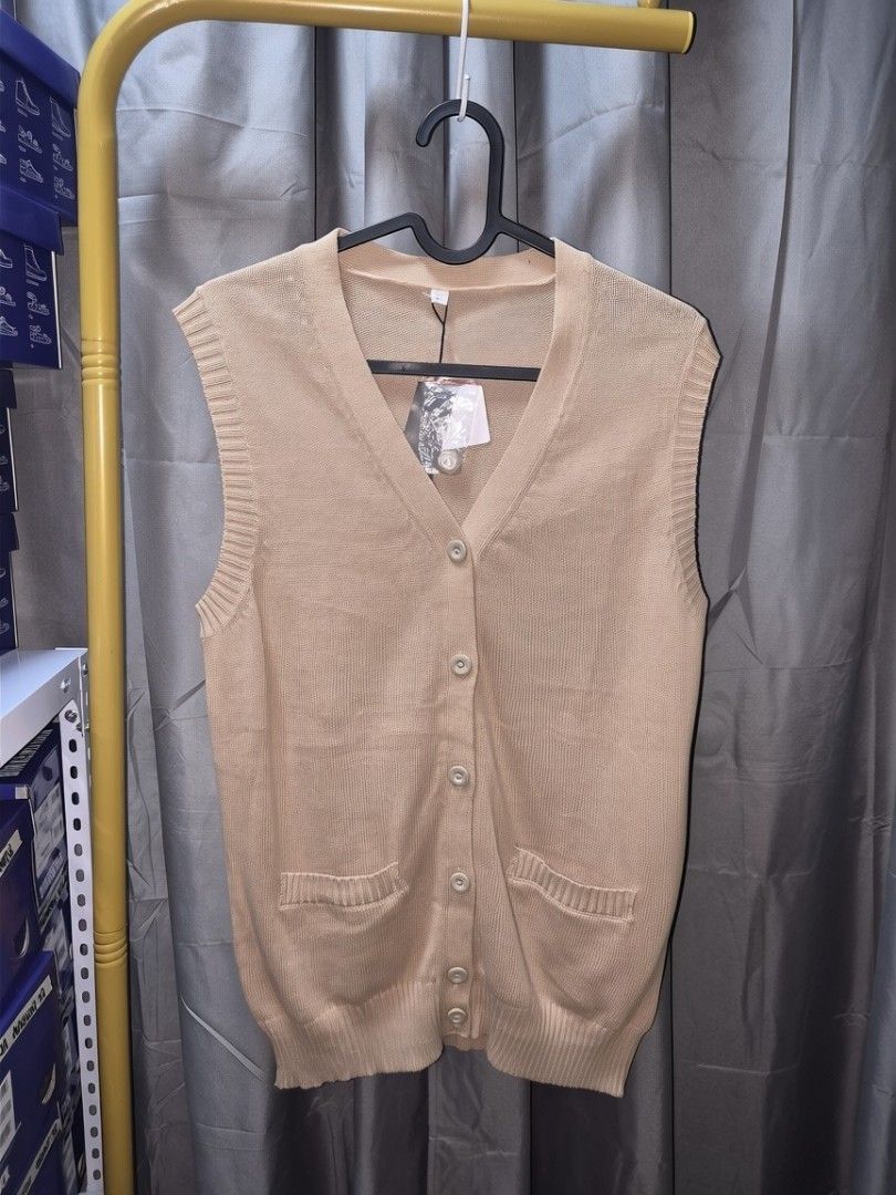 Unisex Knit Button-Up Vest with Pockets (Category: Vests) located in Taguig. Submitted by chloe_clothingco. (Listing ID 1462355466, Image 1). Description: - Classic knit vest - V-neckline - Button-up front - Two front pockets - Ideal for layering - Available in beige and navy.