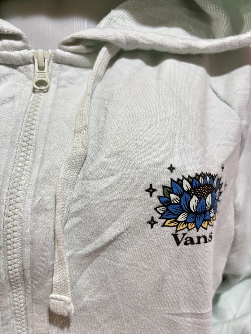 Vans Zip-Up Hoodie - Light Blue - Size Medium (Category: Coats, Jackets and Outerwear) located in Manila. Submitted by danirivera21 (Listing ID 1462438856, Image 2). Description: - Light blue Vans zip-up hoodie - Size: Medium - Graphic: Butterfly and floral design on the back, small Vans logo on the chest - Features: Drawstring hood, front pockets - Style: Great for casual wear.