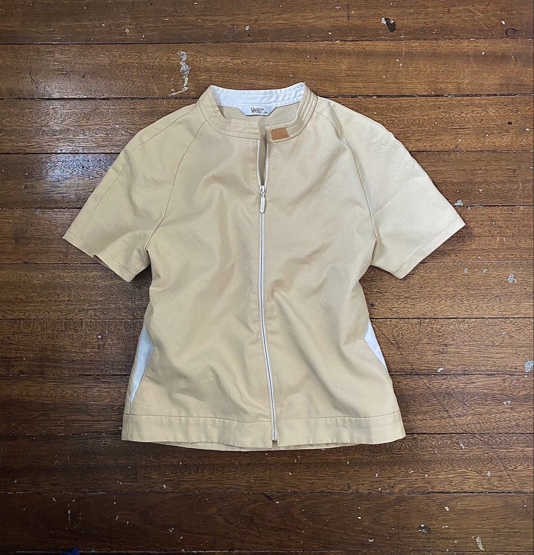 Veeko Beige Zip-Up Short Sleeve Jacket (Category: Coats, Jackets and Outerwear) located in Caloocan City. Submitted by hoellyjane (Listing ID 1462305485, Image 1). Description: - Beige short sleeve jacket from Veeko - Zip-up front closure - Classic white collar - Subtle light blue accents on the sides - Versatile for layering or wearing solo - Effortless to style for any outfit.