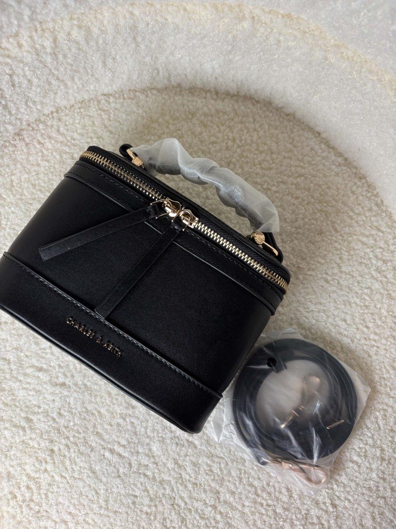 Vietnam C&K Black Vanity Case Bag with Strap (Category: Tote Bags) located in Makati City. Submitted by nixxx000 (Listing ID 1462408623, Image 2). Description: - Brand: VIETNAM C&K - Color: Black - Style: Vanity Case Bag - Features: Top handle, detachable shoulder strap - Hardware: Gold details - Closure: Zipper - Interior: Small pocket - Ideal for: Travel or everyday use.