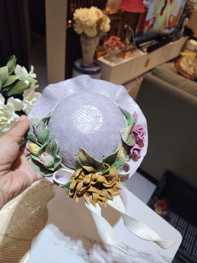 Vintage Ceramic Decorative Hat with Flowers (Category: Other Home Decor) located in Manila. Submitted by monelynbal93172 (Listing ID 1462415637, Image 1). Description: - Cute ceramic hat with floral embellishments - Lilac color with a textured finish - Features a large brown flower and ribbon details - Ideal for display or unique home decor - Adds vintage charm to any space.