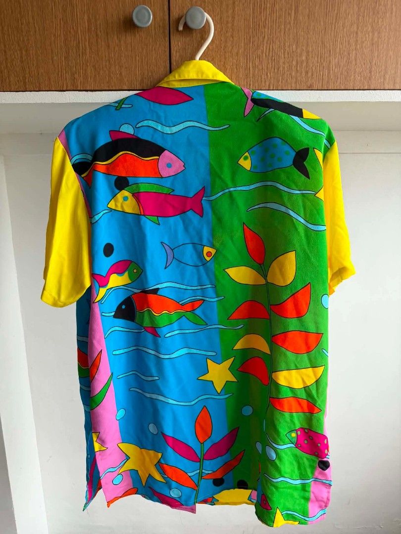 Vintage Funky Fish Print Button Up Shirt (Category: Shirts) located in Manila. Submitted by atozstuff (Listing ID 1462292420, Image 2). Description: - Super fun and colorful button-up shirt - Vibrant fish and underwater plant print - Bright yellow sleeves and collar - Unique design, great for making a statement - Button closure down the front - Perfect for casual wear or a themed party.