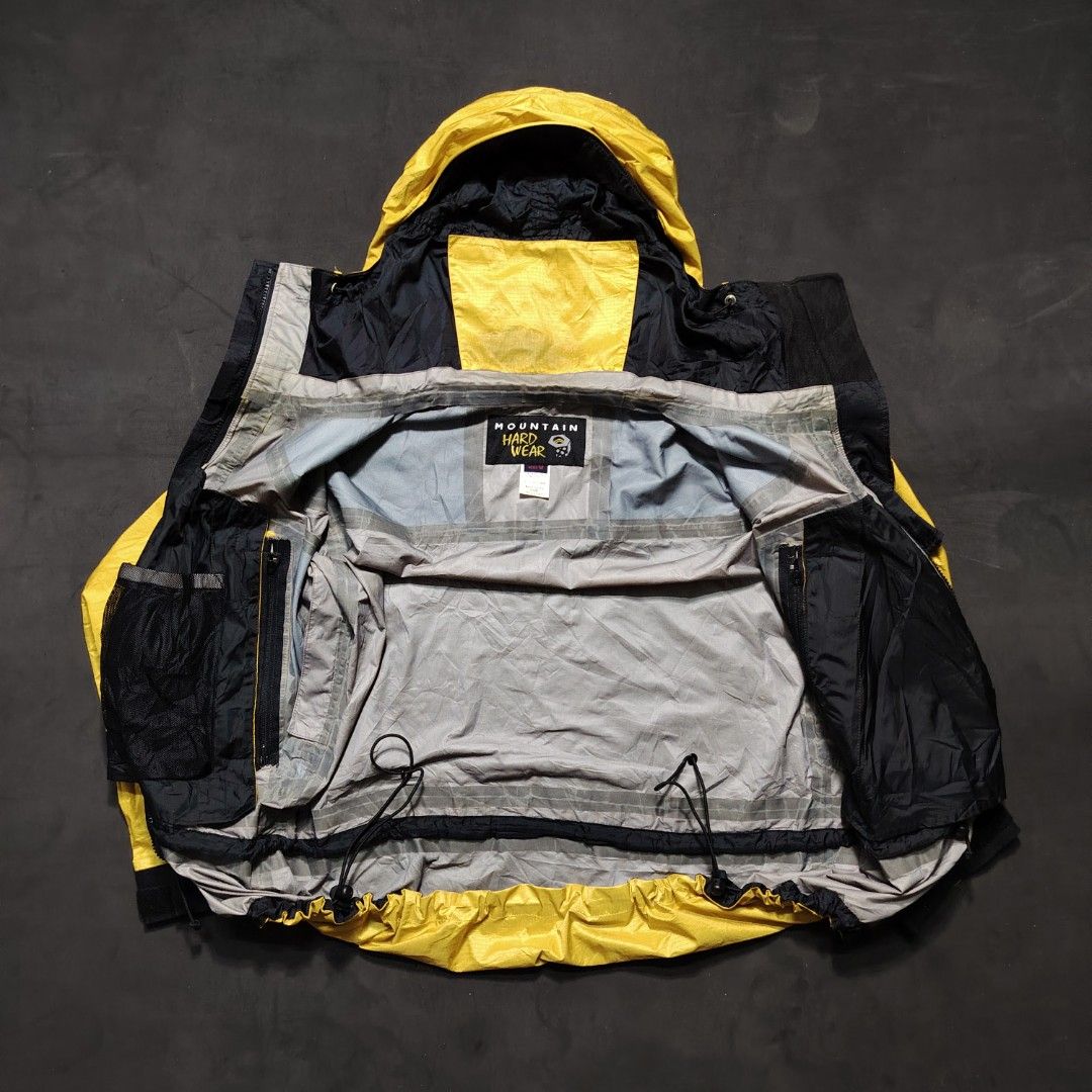Vintage Mountain Hardwear Paradigm Jacket (Category: Coats, Jackets and Outerwear) located in General Santos City (Dadiangas). Submitted by angelodemegilloceballos (Listing ID 1462430140, Image 2). Description: - Brand: Mountain Hardwear - Color: Yellow and Black - Type: Shell Jacket - Size: Men's Medium (M) - Features: Hooded with adjustable drawstrings, Zipper closure, Two front pockets - Ideal for: Outdoor activities and adventures.