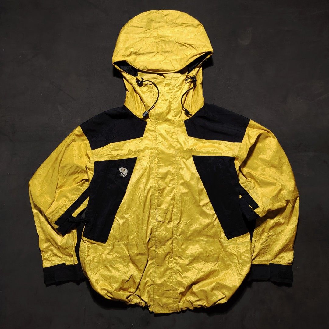 Vintage Mountain Hardwear Paradigm Jacket (Category: Coats, Jackets and Outerwear) located in General Santos City (Dadiangas). Submitted by angelodemegilloceballos (Listing ID 1462430140, Image 1). Description: - Brand: Mountain Hardwear - Color: Yellow and Black - Type: Shell Jacket - Size: Men's Medium (M) - Features: Hooded with adjustable drawstrings, Zipper closure, Two front pockets - Ideal for: Outdoor activities and adventures.