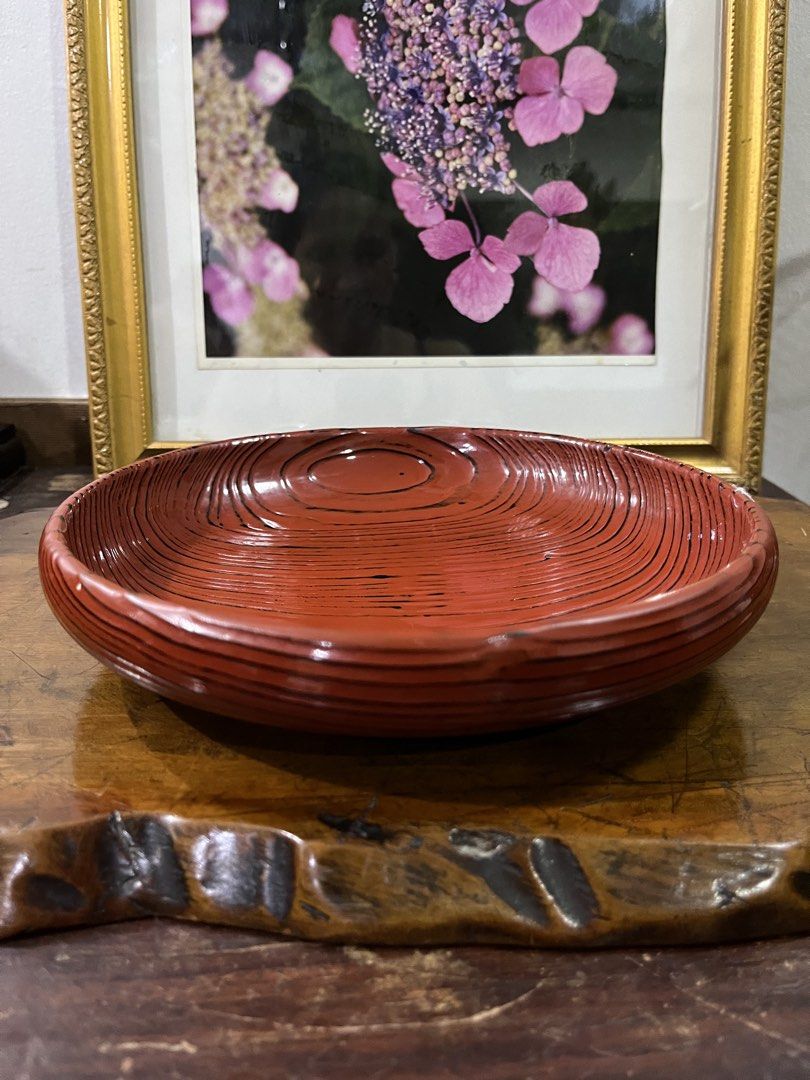 Vintage Red Lacquer Serving Bowl with Black Lines (Category: Dinnerware & Cutlery) located in Taguig. Submitted by minmin_parker (Listing ID 1462400286, Image 3). Description: - Vintage red lacquer serving bowl - Unique wood grain pattern with black line details - Ideal for serving snacks or as a decorative piece - Shows some signs of wear consistent with age - Approximately 8 inches in diameter - Adds a vintage touch to any table setting.