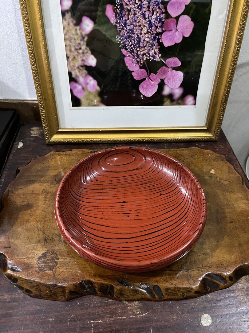 Vintage Red Lacquer Serving Bowl with Black Lines (Category: Dinnerware & Cutlery) located in Taguig. Submitted by minmin_parker (Listing ID 1462400286, Image 1). Description: - Vintage red lacquer serving bowl - Unique wood grain pattern with black line details - Ideal for serving snacks or as a decorative piece - Shows some signs of wear consistent with age - Approximately 8 inches in diameter - Adds a vintage touch to any table setting.