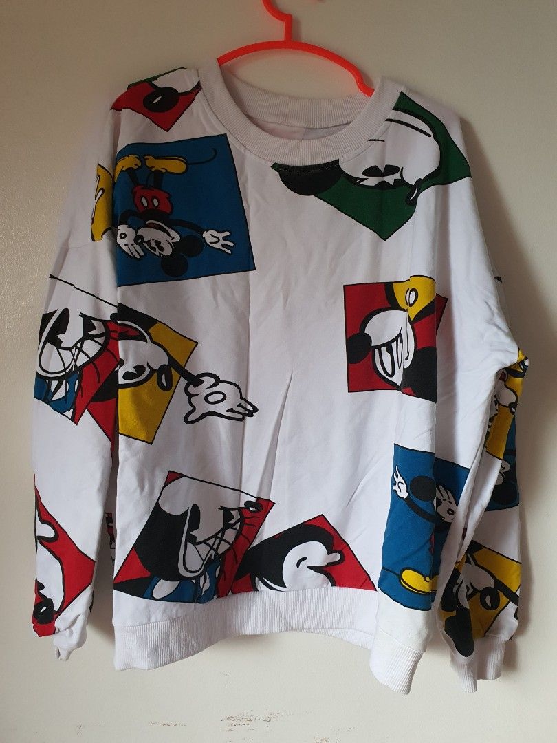 White Mickey Mouse Graphic Sweatshirt (Category: Longsleeves) located in Meycauayan. Submitted by shoptoown (Listing ID 1462268551, Image 1). Description: - White sweatshirt with a fun all-over Mickey Mouse graphic print. - Features various poses and colors of Mickey. - Ribbed cuffs and neckline for a comfortable fit. - Ideal for casual everyday wear. - Measurements: Pit to pit approx. 23 inches, Length approx. 23 inches..