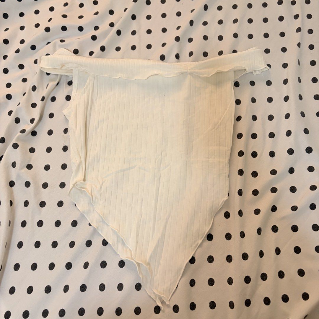 White Ribbed Off-Shoulder top (Category: Others Tops) located in Pasay City. Submitted by notellyyyy (Listing ID 1462278626, Image 1). Description: - White ribbed bodysuit - Off-shoulder design with ruffled neckline - Asymmetrical hemline - Stretchy material for a comfortable fit - Ideal for layering or wearing as a standalone piece - Pairs perfectly with jeans or skirts.