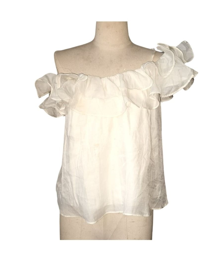 White Ruffled Off-the-Shoulder Top (Category: Blouses) located in Caloocan City. Submitted by avezam (Listing ID 1462365808, Image 1). Description: - Cute white off-the-shoulder top - Features delicate ruffles - Made of sheer fabric - Ideal for beach days or casual outings - Versatile: pairs easily with shorts or jeans - Note: has a few faint marks on the front.