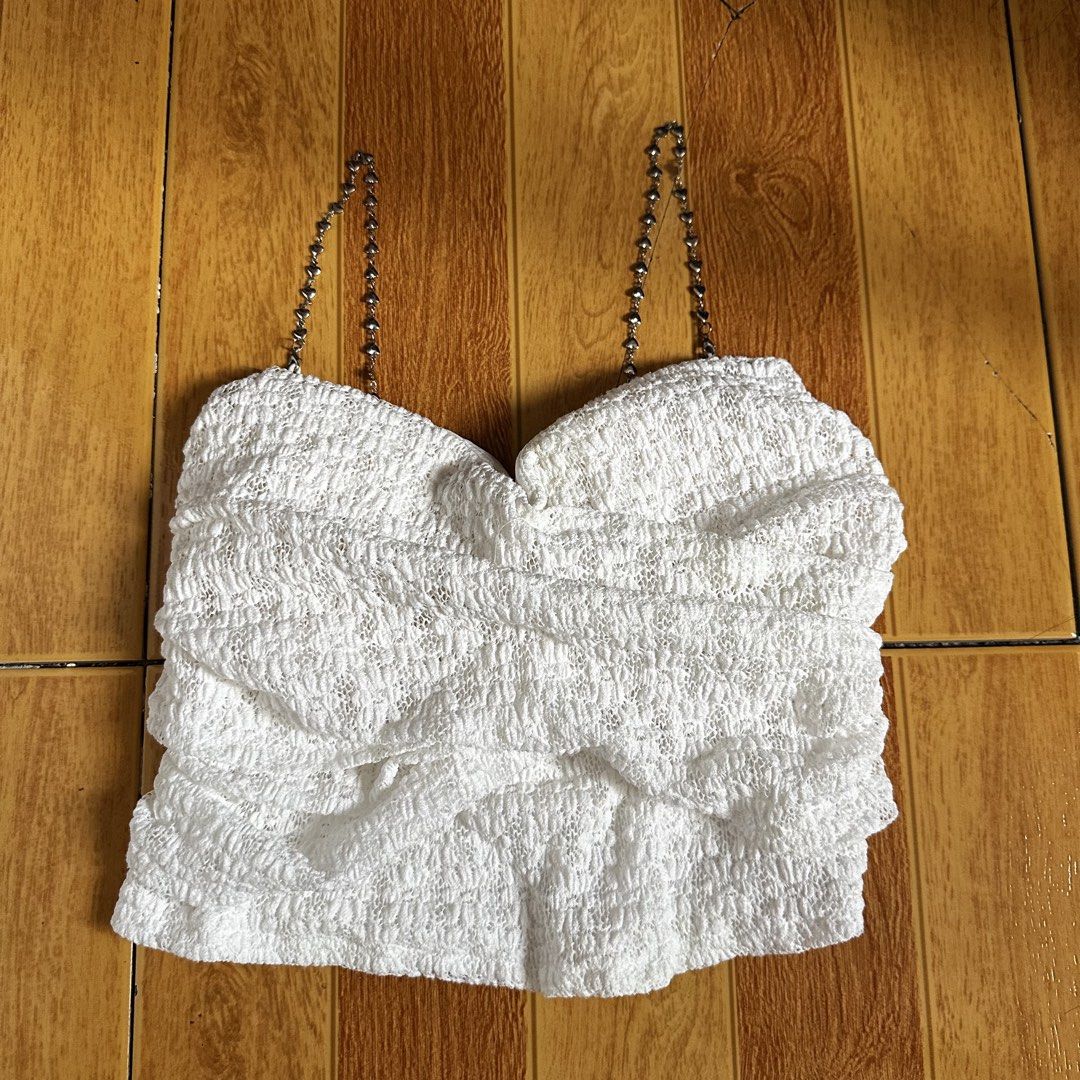 White Smocked Ruffle Crop Top with Chain Straps (Category: Sleeveless) located in Manila. Submitted by daintywears (Listing ID 1462308525, Image 3). Description: please manage your expectations this is a thrifted item. padded already na, the silver straps can be removed. pwede maging tube lang see photos. only flaw: natanggal yung isa pero since de-hook naman pinasok ko siya and yes nagwork naman. wore once only. xs-s or keri hanggang semi m din.