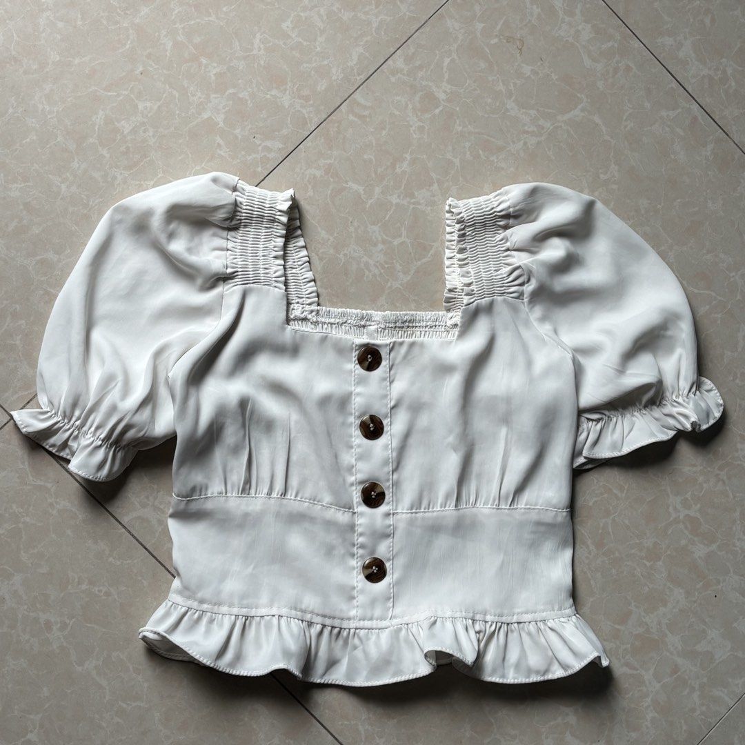 White Square Neck Puff Sleeve Button Up Peplum Top (Category: Blouses) located in Manila. Submitted by glenkm (Listing ID 1462292336, Image 1). Description: - White top with puff sleeves. - Smocked detailing on sleeves and back. - Soft fabric Shipping: Lalamove or J&T (65 pesos) .