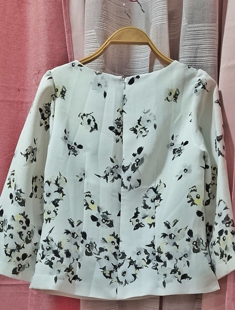 Willselection floral three-quarter sleeve blouse (Category: Blouses) located in Cabanatuan. Submitted by miss.maia (Listing ID 1462395187, Image 3). Description: The item in the image is a Willselection floral three-quarter sleeve blouse. It features an elegant off-white baseline decorated with a monochrome watercolor floral print that clusters more densely toward the hemline. The garment is crafted with a wide crew neckline, structured dart styl