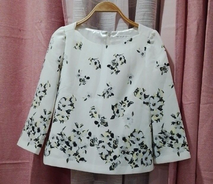 Willselection floral three-quarter sleeve blouse (Category: Blouses) located in Cabanatuan. Submitted by miss.maia (Listing ID 1462395187, Image 2). Description: The item in the image is a Willselection floral three-quarter sleeve blouse. It features an elegant off-white baseline decorated with a monochrome watercolor floral print that clusters more densely toward the hemline. The garment is crafted with a wide crew neckline, structured dart styl