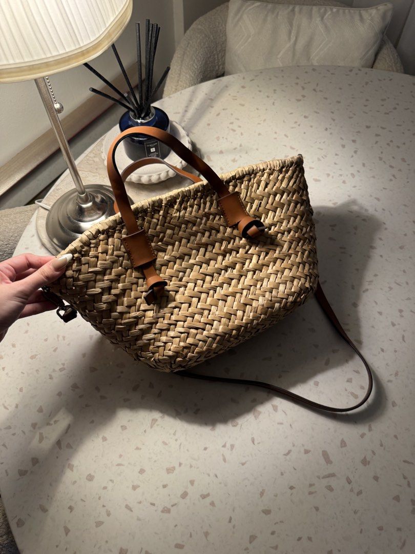 Woven Straw Tote Bag with Leather Handles (Category: Tote Bags) located in Las Pinas. Submitted by patringcia_14 (Listing ID 1462329800, Image 3). Description: - Cute woven straw tote bag - Natural straw color with brown leather accents - Zippered inner pouch for essentials - Magnetic snap closure - Top handles - Detachable shoulder strap - Ideal for beach days or everyday errands - Spacious enough for daily necessities.