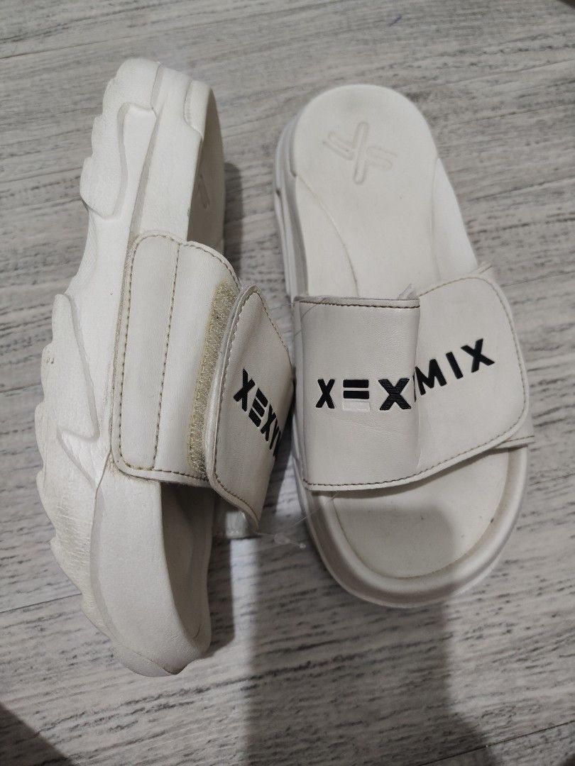 XEXYMIX White Slides Sandals - US6 (Category: Slippers and slides) located in Calamba. Submitted by an_ne0501 (Listing ID 1462296692, Image 2). Description: - Brand: XEXYMIX - US6 | EU36-37| 23cm - Color: White - Style: Slides - Features: Comfortable, easy to wear - Design: XEXYMIX logo on straps and sole - Sole: Grippy pattern for traction - Occasion: Ideal for casual wear.