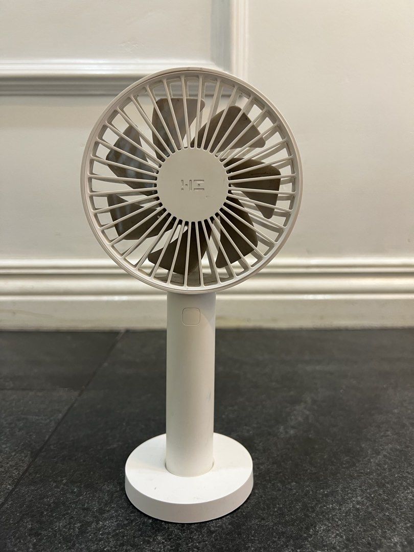 XIAOMI White HE Portable Desk Fan with Base (Category: Fans) located in Pasig City. Submitted by yonghan0613 (Listing ID 1462318400, Image 1). Description: - Portable white desk fan - Stable round base - 'HE' logo on front grille - Ideal for personal cooling - Easy to move around - Works well.