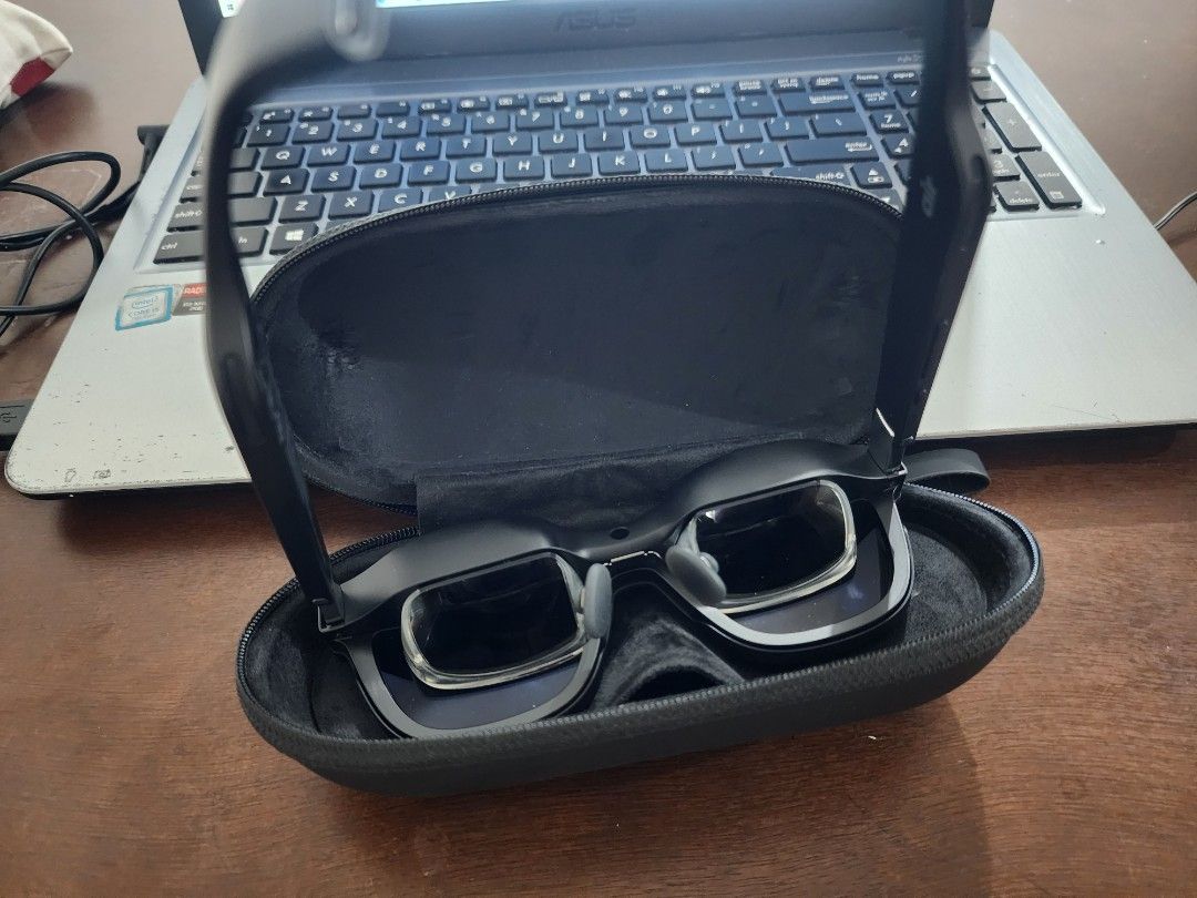 XREAL / Nreal Air AR Smart Glasses (Complete with Case & Cable) (Category: Virtual Reality) located in Pasig City. Submitted by jam1ekow (Listing ID 1462385462, Image 3). Description: Selling my personal XREAL Air AR Smart Glasses (originally branded as Nreal Air). If you are looking for a portable theater or a private massive screen for gaming and productivity on the go, this is perfect for you! Connects directly via USB-C to compatible devices 