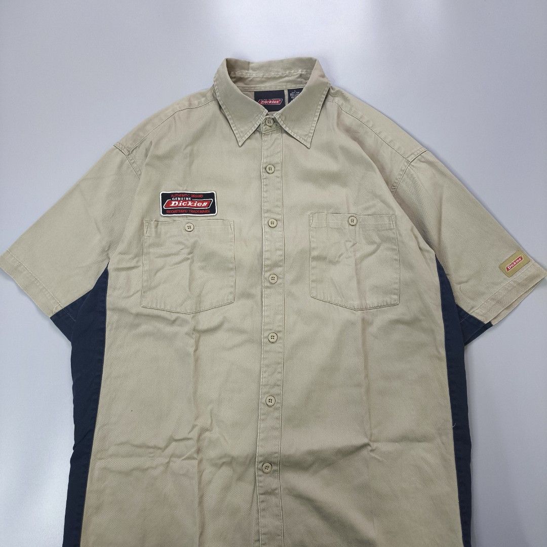 Y2k Dickies Short Sleeve Work Shirt (Category: Tshirts & Polo Shirts ) located in Calamba. Submitted by adi_thrift (Listing ID 1462422154, Image 2). Description: - Dickies Work Shirt - Width 24 / Length 29.5 - Color: Tan with Navy Blue Side Panels - Sleeve Length: Short Sleeves - Closure: Button-up Front - Pockets: Two Chest Pockets - Branding: Classic Dickies Logo Patch on Chest & Sleeve Tag - Size: Large (L) - Material: 100% Cotton.